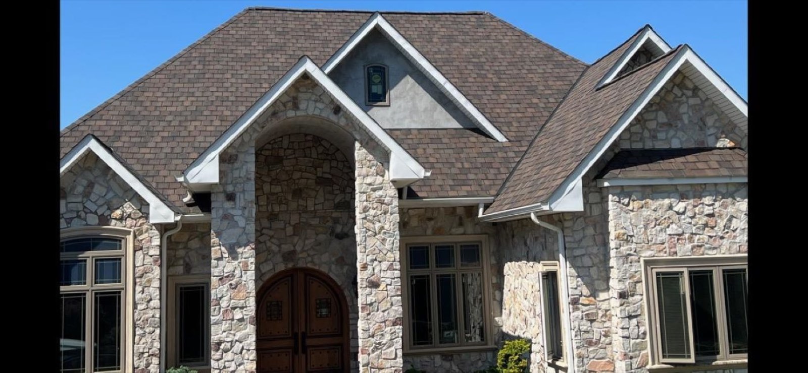 Residential roof with architectural asphalt shingles on a stone home in Chester County, Pennsylvania