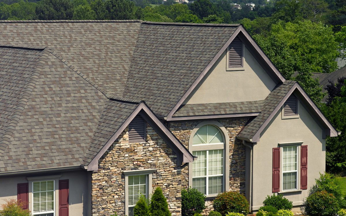 Stone-front home with a CertainTeed Landmark architectural shingle roof