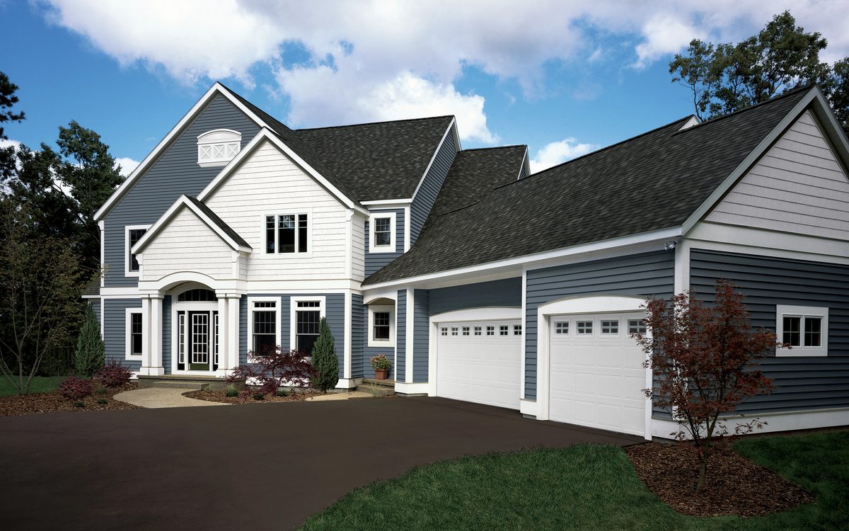 Two-story home with a dark architectural shingle roof and gray lap siding